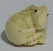 A bone netsuke formed as a mouse