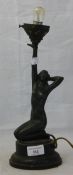 An Art Deco figural lamp formed as a nude woman