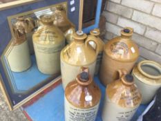 A small quantity of stoneware bottles and a Harveys mirror