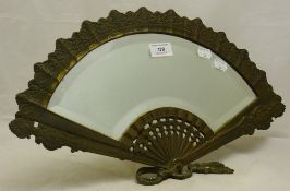 A brass table mirror of fan form