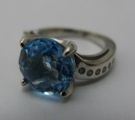 A silver blue stone dress ring