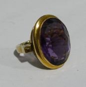 An unmarked yellow metal amethyst set ring (11 grammes all in)