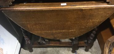 An early 20th century oak barley twist gate leg table