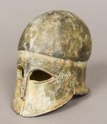 A bronze terracotta model of a Greek helmet 10 cm high.