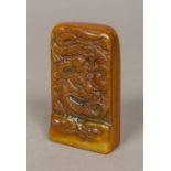 A Chinese carved soapstone seal Of tablet form, decorated with a figure riding a dragon,
