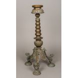 A 19th century Indian brass butter lamp The dished top above the knopped stem above three cast
