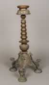 A 19th century Indian brass butter lamp The dished top above the knopped stem above three cast