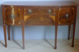 A George III mahogany bow front sideboard The line inlaid shaped top above three inlaid drawers and