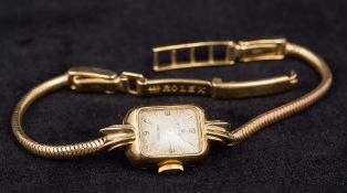 A 9 ct gold cased lady's Rolex wristwatch The signed rectangular dial with Arabic numerals and gold