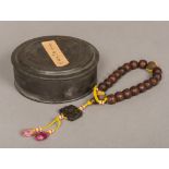 A Chinese string of carved agarwood or Chen Xiang beads Two with gilt decoration,