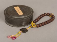 A Chinese string of carved agarwood or Chen Xiang beads Two with gilt decoration,