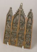 A patinated bronze religious icon Of Gothic arched architectural form,