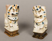 A pair of 19th century Chinese pottery joss stick holders Each modelled as a temple dog,