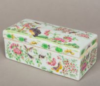 A 19th century Canton porcelain box and cover The removable domed rectangular lid painted with