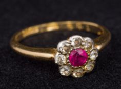 A gold, diamond and ruby set flowerhead ring Size K.