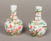 A pair of 19th century Chinese porcelain vases Each painted in the round with fruiting peach trees,