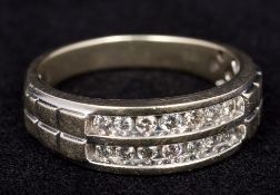A 10K gold and diamond ring Set with two rows of diamonds. 7 mm high.