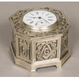 An unmarked silver cased desk timepiece The hinged lid inset with a plated watch,