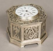 An unmarked silver cased desk timepiece The hinged lid inset with a plated watch,