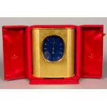 A Patek Philippe Ellipse D'Or Solar clock The blue dial with batons, in the gilt brushed brass case,