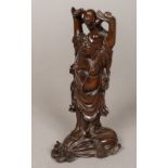 A Chinese finely carved wooden model of Buddha Modelled holding aloft a small child,