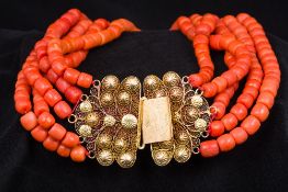 An unmarked 18 ct gold mounted coral bead necklace Of five strand form. Approximately 43 cm long.