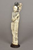 A late 19th/early 20th century Chinese carved ivory figure of Guanyin Standing on a carved wood