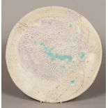 A Studio pottery raku type glazed dish With turquoise splashes, unsigned. 41 cm diameter.