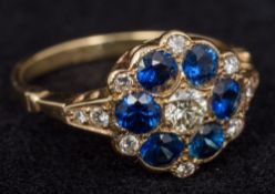 An Edwardian 18 ct gold diamond and sapphire set cluster ring Size M, cased.