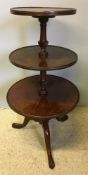 A George III plum pudding mahogany three tier dumb waiter Each tier of dished moulded circular form,