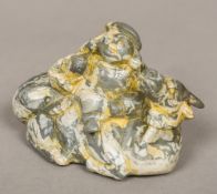 A Chinese carved green and cream banded chalcedony group Worked as a daikoku seated on a recumbent