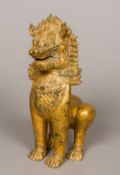 An Eastern gilt bronze Buddhistic lion, probably Burmese Typically modelled. 27.5 cm high.