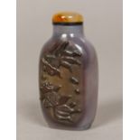 A Chinese agate snuff bottle Carved to one side with two fish. 6.25 cm high.