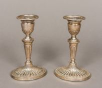 A pair of silver candlesticks, hallmarked London 1966, maker's mark of DJS 17.35 cm high.