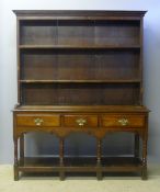An 18th century oak dresser The moulded rectangular cornice above two shelves,