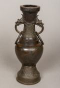 A 17th century Chinese bronze twin handled vase The ring handles dragon mask headed,