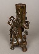 An 18th century Chinese patinated bronze vase Modelled as a dignitary and a stag standing before a