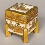 A 19th century Japanese Satsuma box and cover Of square section form, with gilt heightened legs,