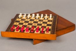 A late 19th century mahogany cased white and red stained ivory travelling chess set Of typical box