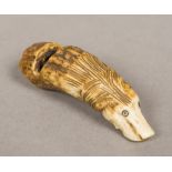 A novelty carved antler whistle Formed as a dog's head. 6 cm long.