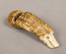 A novelty carved antler whistle Formed as a dog's head. 6 cm long.