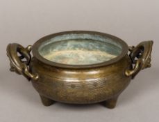 A antique Chinese patinated bronze censer Of squat circular form,