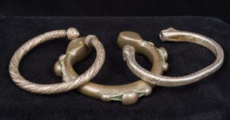 Two white metal silvered bangles One worked as a double headed serpent;