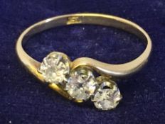 A diamond set 18 ct gold three stone ring Each approximately 0.125 carats.