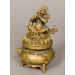 A Sino-Tibetan cast bronze censer and cover With seated deity finial,