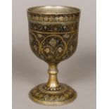 A gilt and niello decorated white metal chalice,