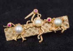 A 14K gold and pearl set bar brooch Formed as three stylised birds. 4.75 cm wide.