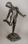 A large patinated bronze statue Formed as a young boy having been bitten by a crab,