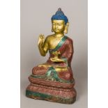 A Chinese over painted cast metal Buddha 44 cm high.