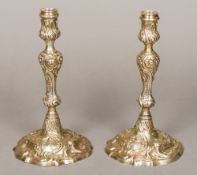 A matched pair of Georgian cast silver candlesticks, one hallmarked London 1757,
